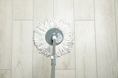 Photo of String mop on wooden floor, above view