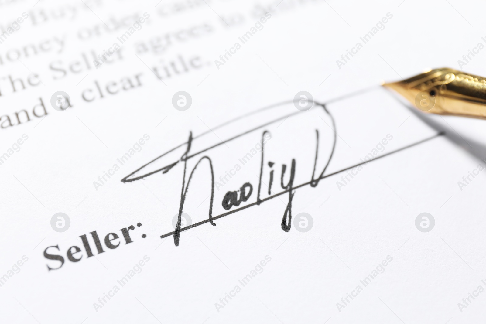 Photo of Fountain pen leaving signature on contract, closeup