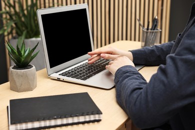 Photo of Woman working on computer at desk indoors, closeup