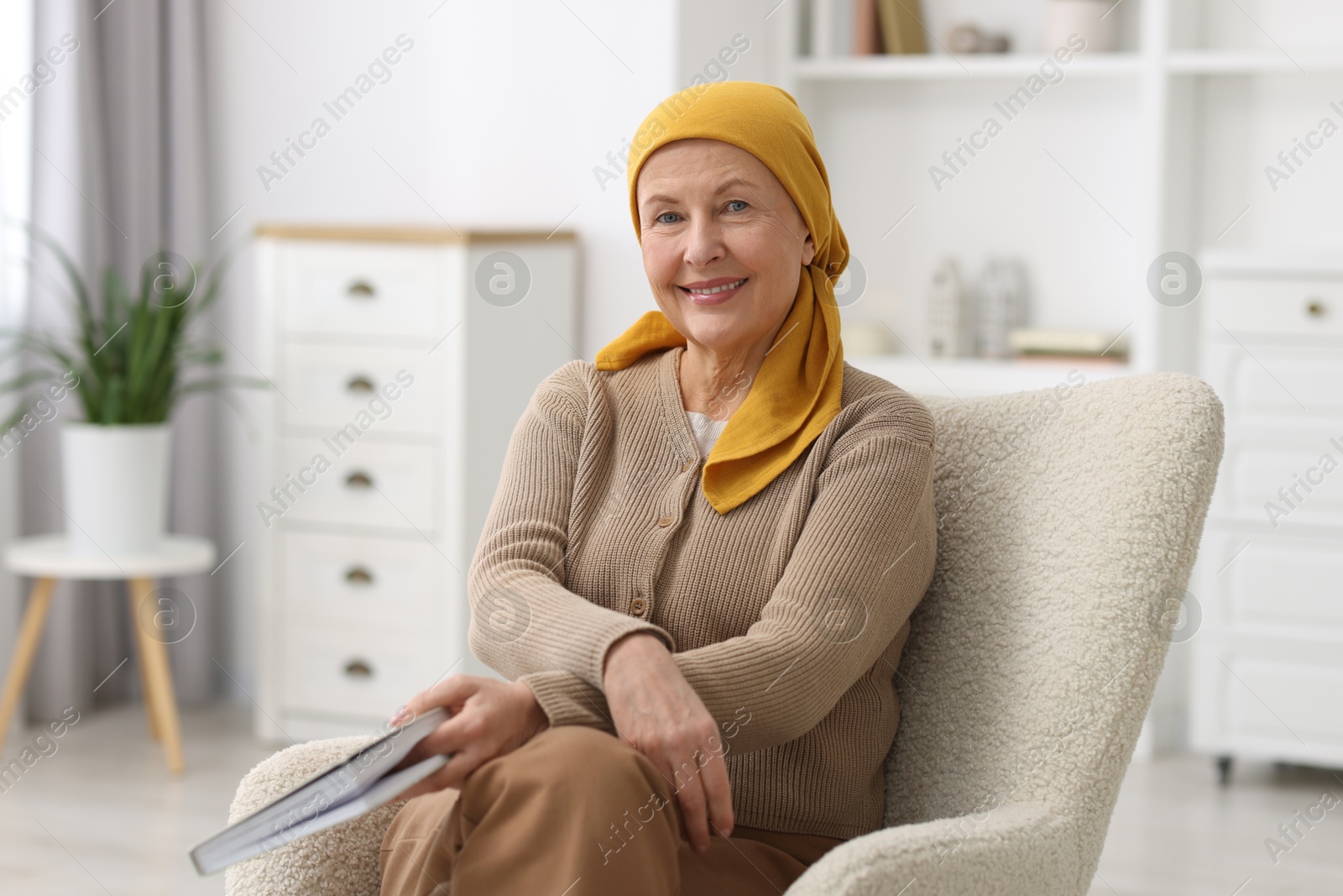 Senior woman with cancer on armchair at home Photo of Senior woman with cancer on armchair at home