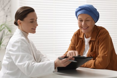 Photo of Senior woman with cancer visiting oncologist in clinic