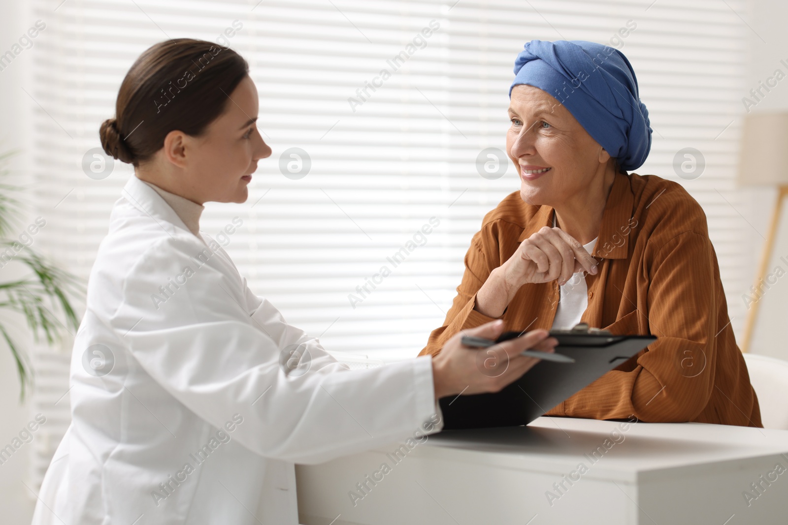 Photo of Senior woman with cancer visiting oncologist in clinic