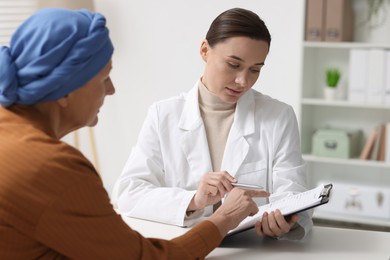 Photo of Senior woman with cancer visiting oncologist in clinic