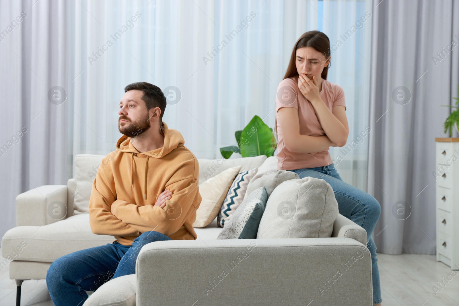 Photo of Resentful couple in living room. Relationship problem