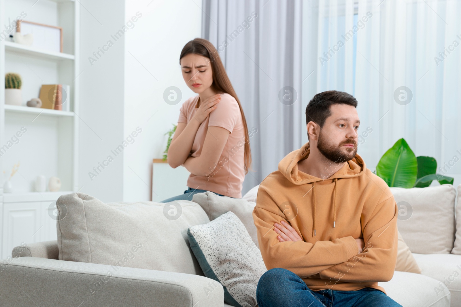 Photo of Resentful couple in living room. Relationship problem