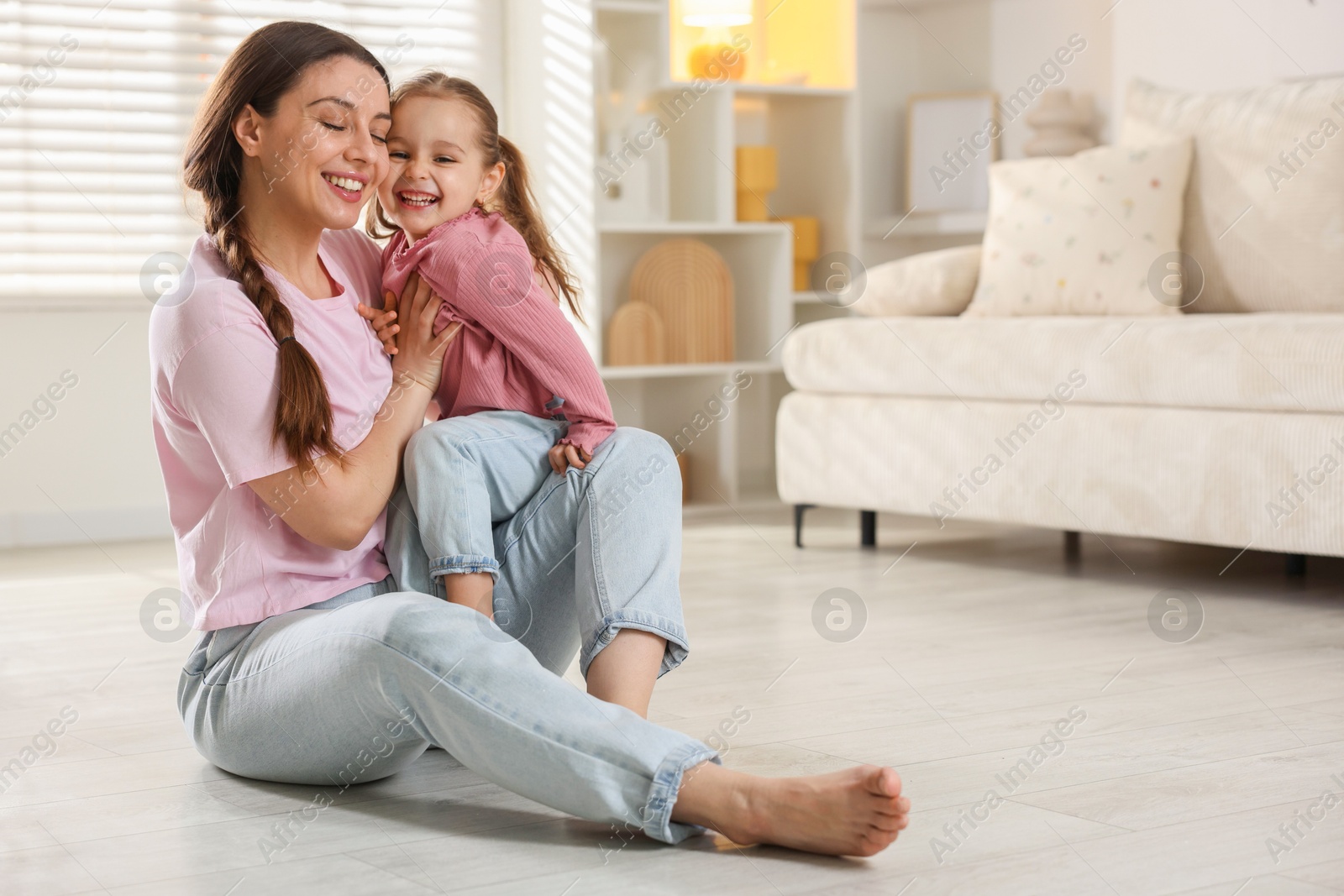 Photo of Happy mother with little daughter spending time together at home. Space for text