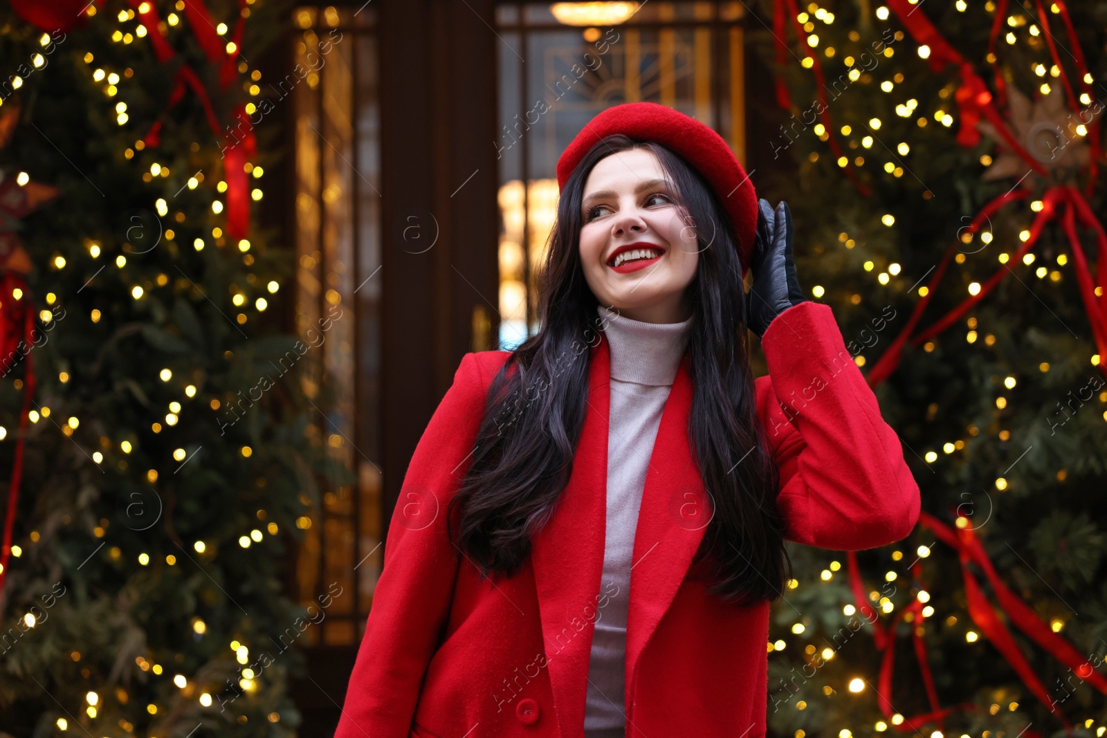 Photo of Portrait of happy woman on city street. Christmas season