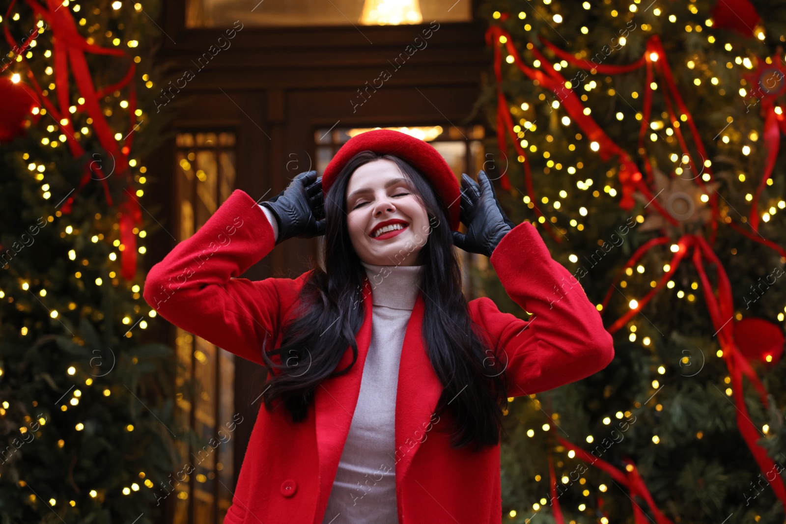 Photo of Portrait of happy woman on city street. Christmas season