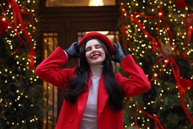 Photo of Portrait of happy woman on city street. Christmas season