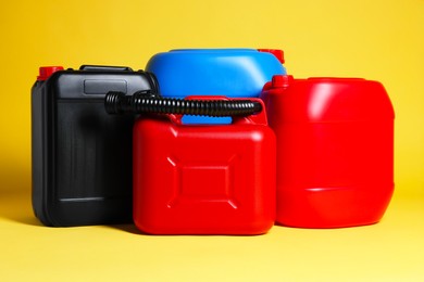 Photo of Many different plastic canisters on yellow background