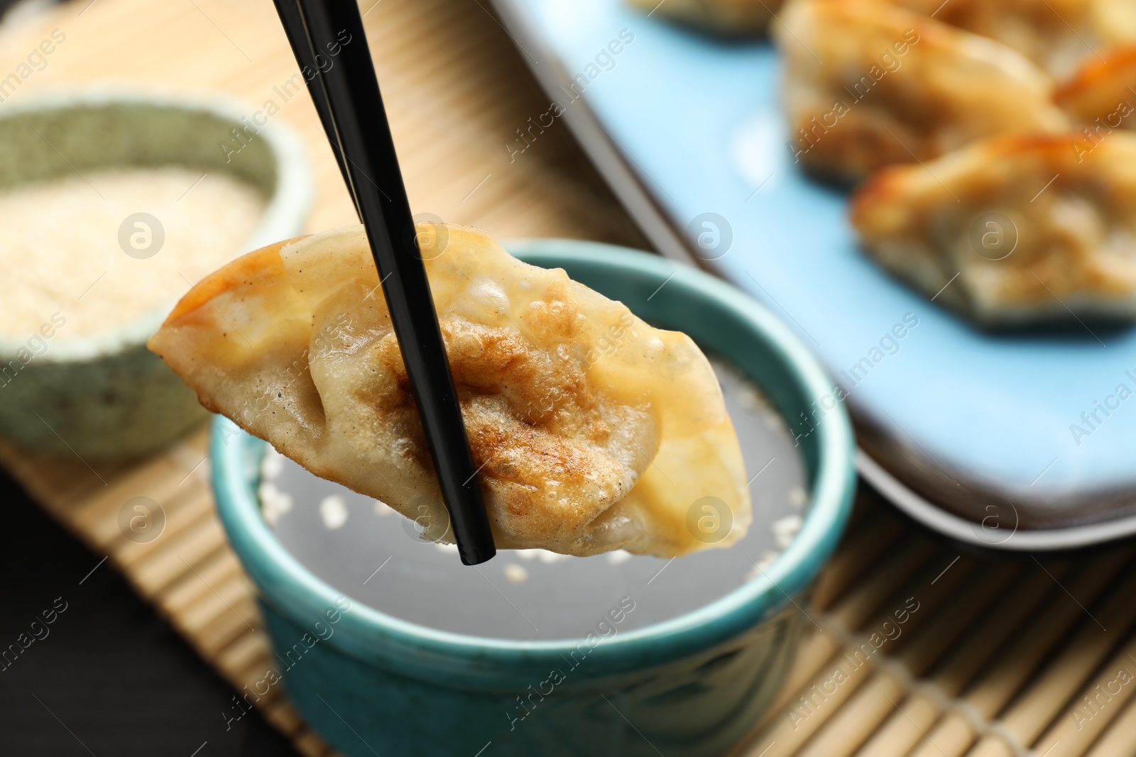 Photo of Eating fried gyoza dumplings at table, closeup