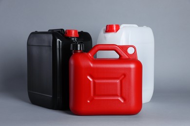 Photo of Many different plastic canisters on light grey background