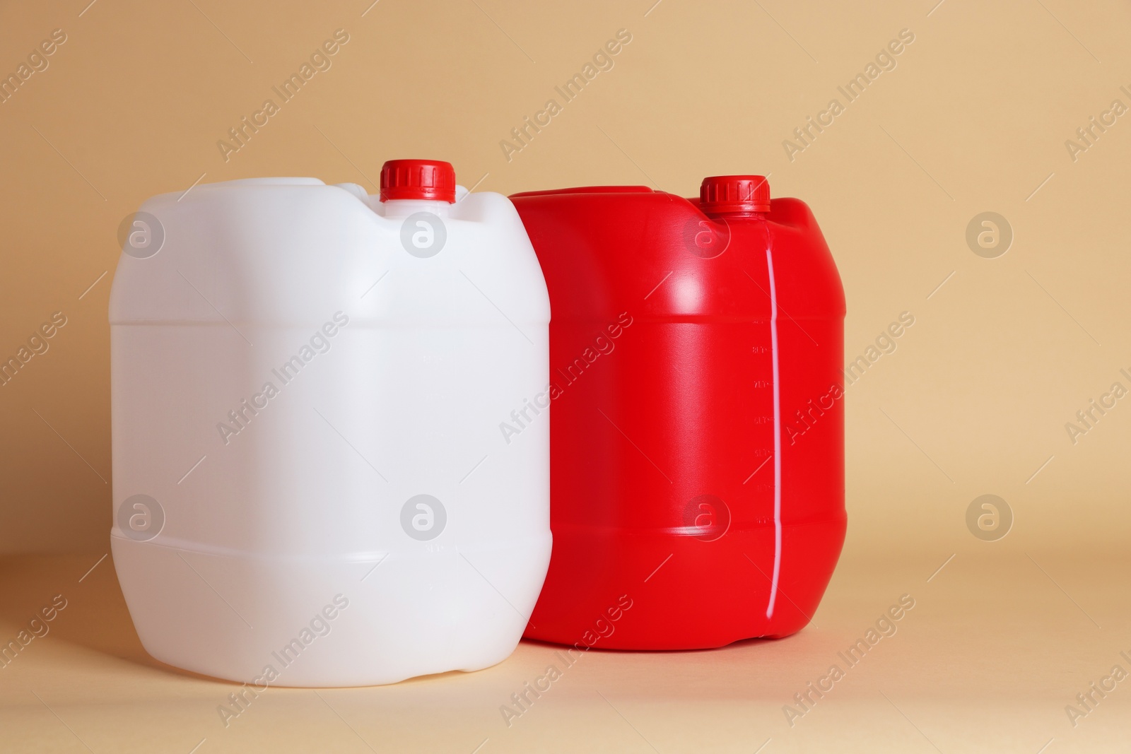 Photo of Two clean plastic canisters on beige background