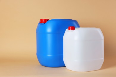 Photo of Two clean plastic canisters on beige background