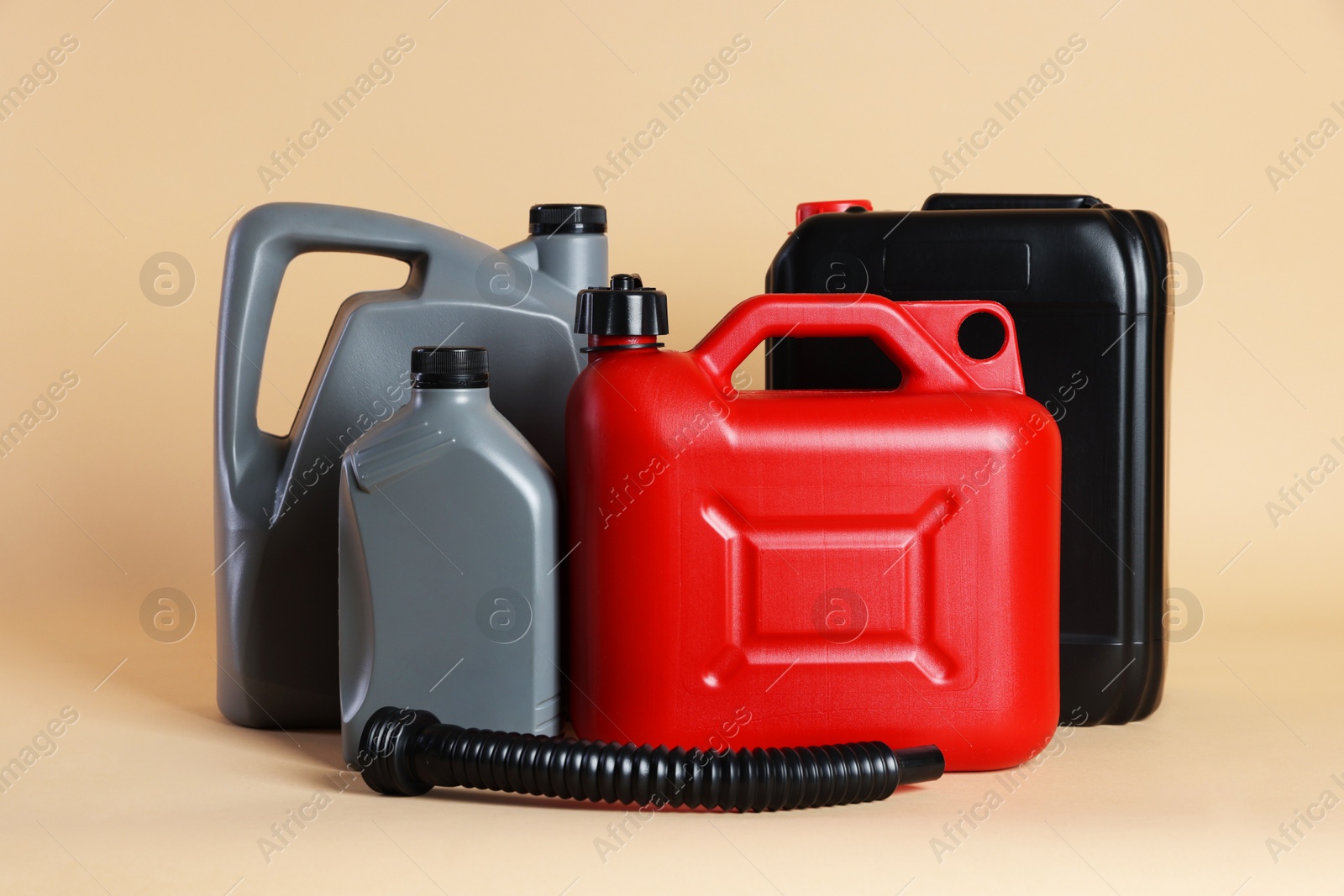 Photo of Many different plastic canisters on beige background