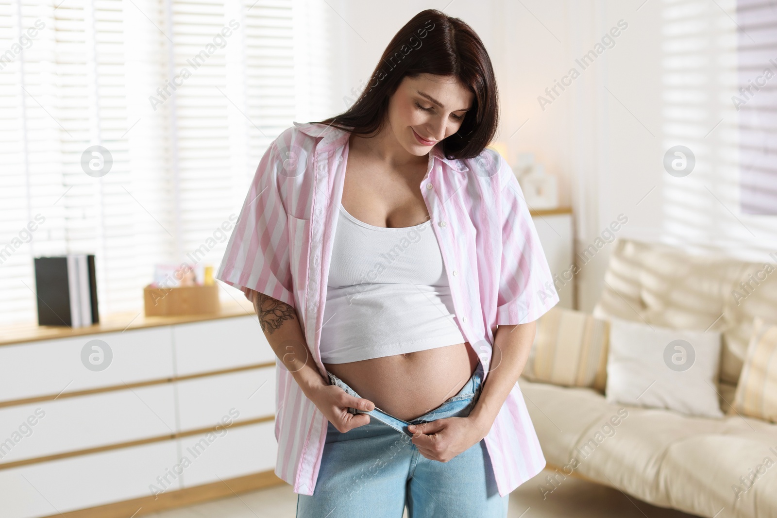 Photo of Beautiful pregnant woman with cute belly at home