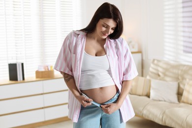 Beautiful pregnant woman with cute belly at home