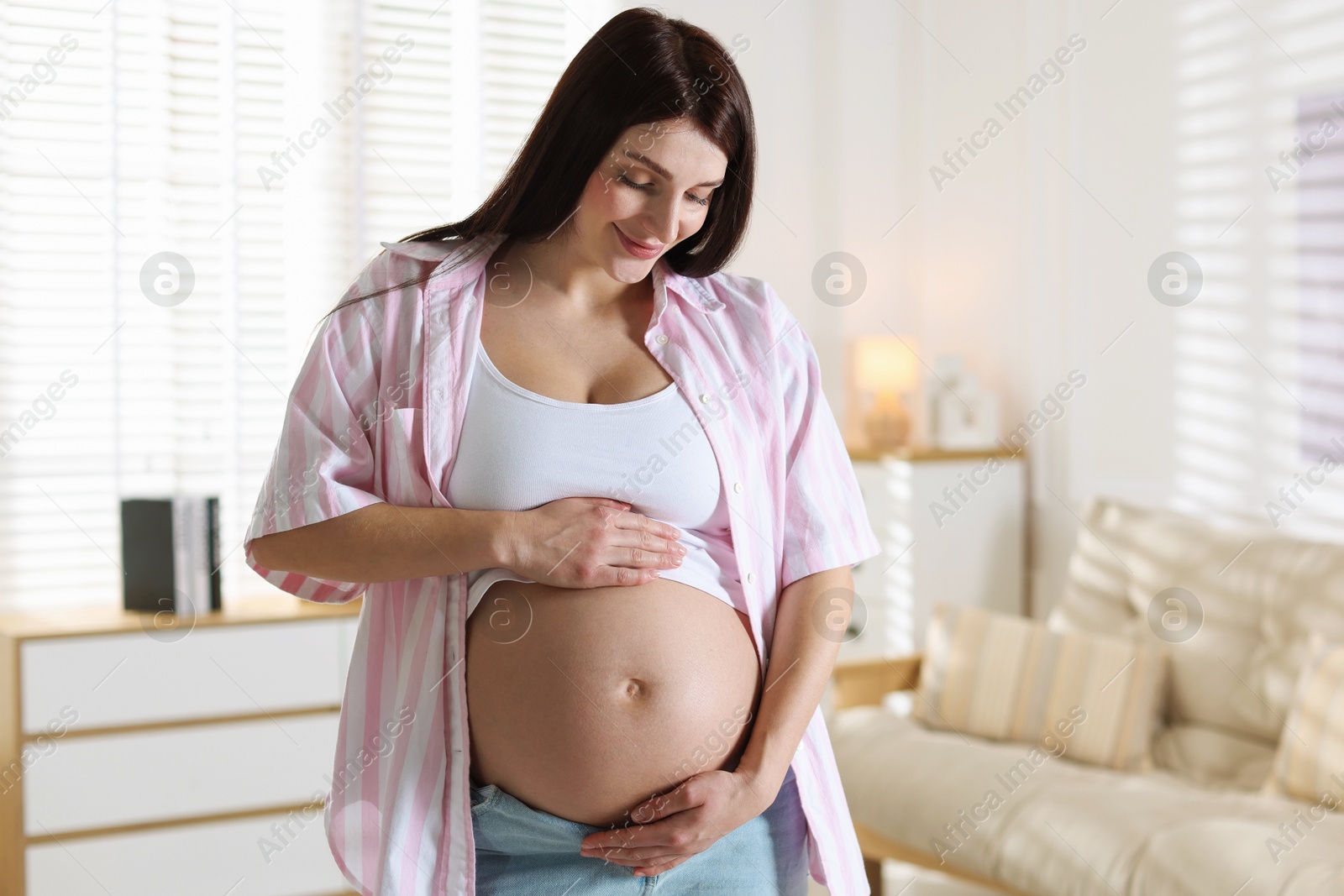 Photo of Beautiful pregnant woman with cute belly at home