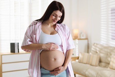 Photo of Beautiful pregnant woman with cute belly at home