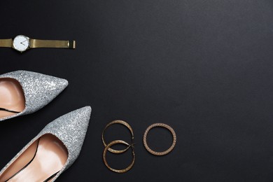 Beautiful shoes and stylish accessories on black background, flat lay. Space for text