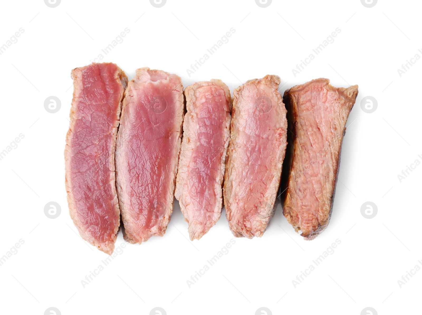 Photo of Delicious sliced beef tenderloin with different degrees of doneness isolated on white, top view