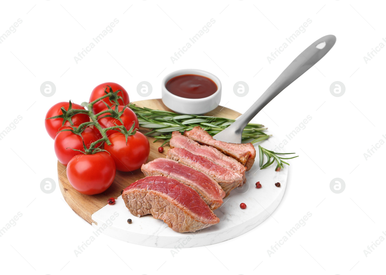 Photo of Delicious sliced beef tenderloin with different degrees of doneness, tomatoes, sauce and spices isolated on white