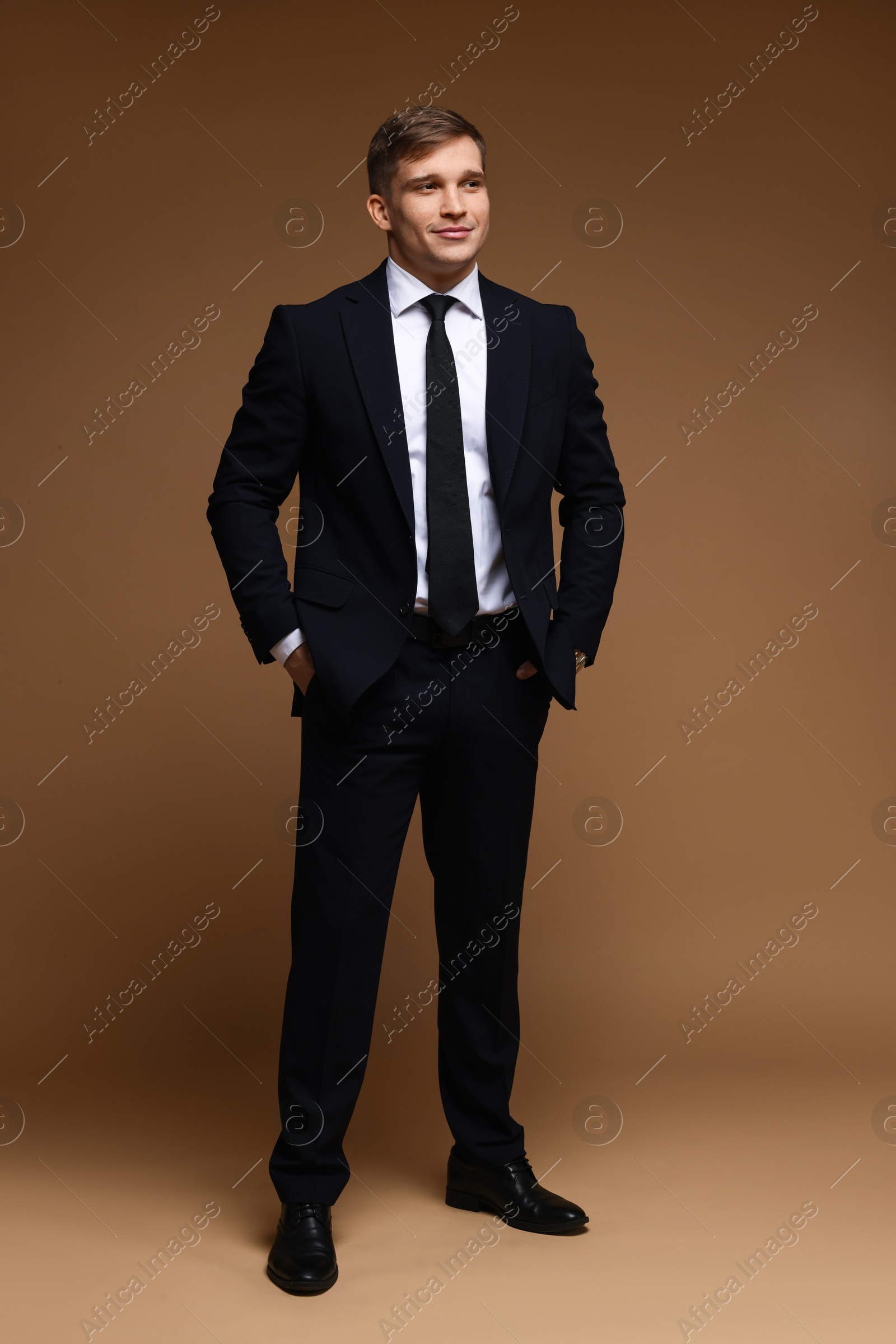 Photo of Man in classic suit on brown background