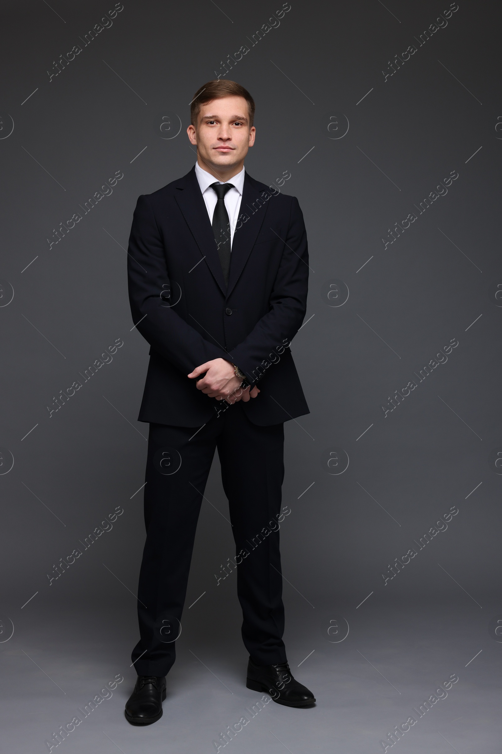 Photo of Man in classic suit on grey background