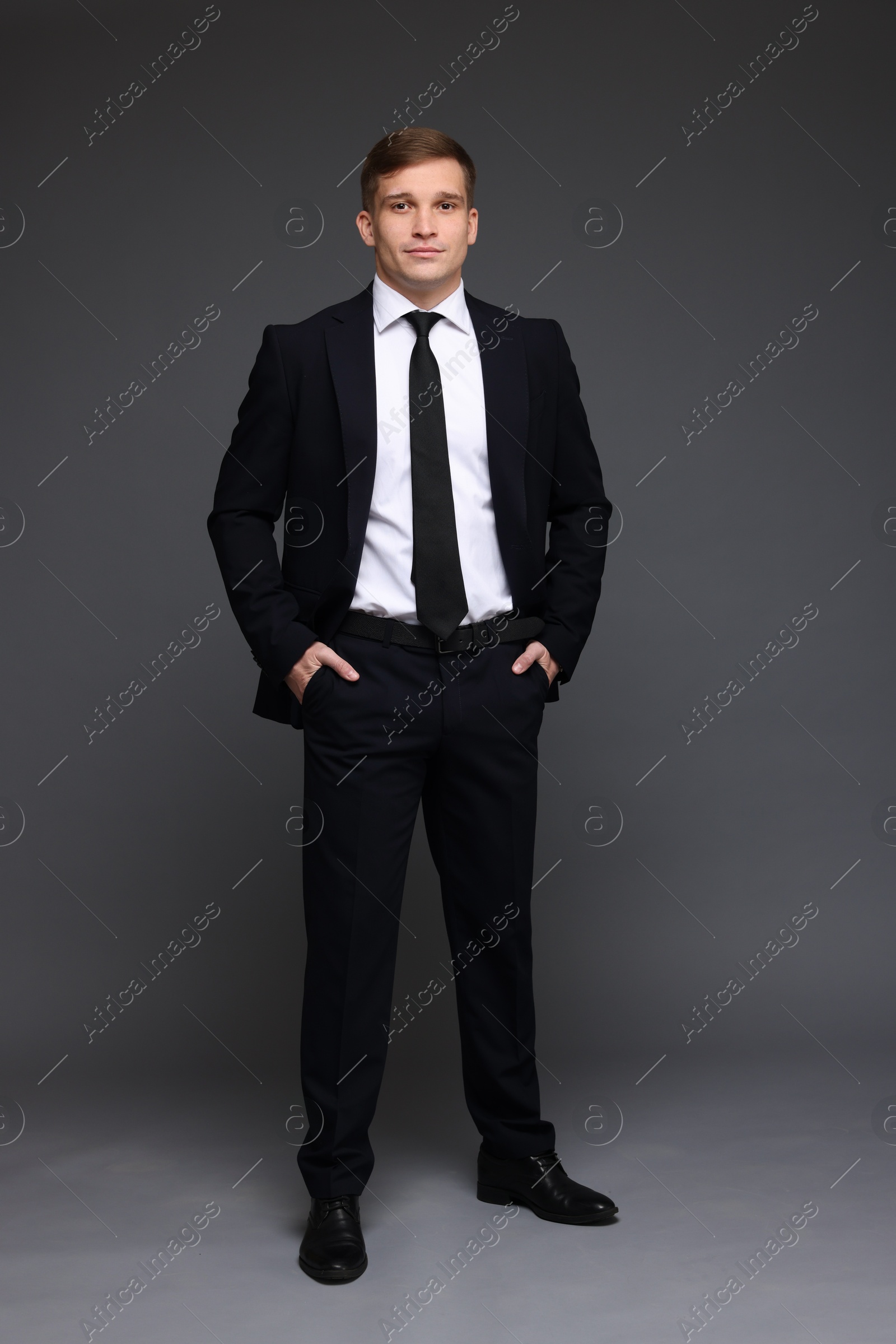 Photo of Man in classic suit on grey background