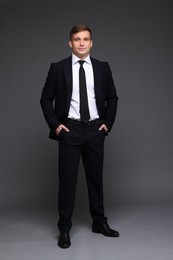 Man in classic suit on grey background