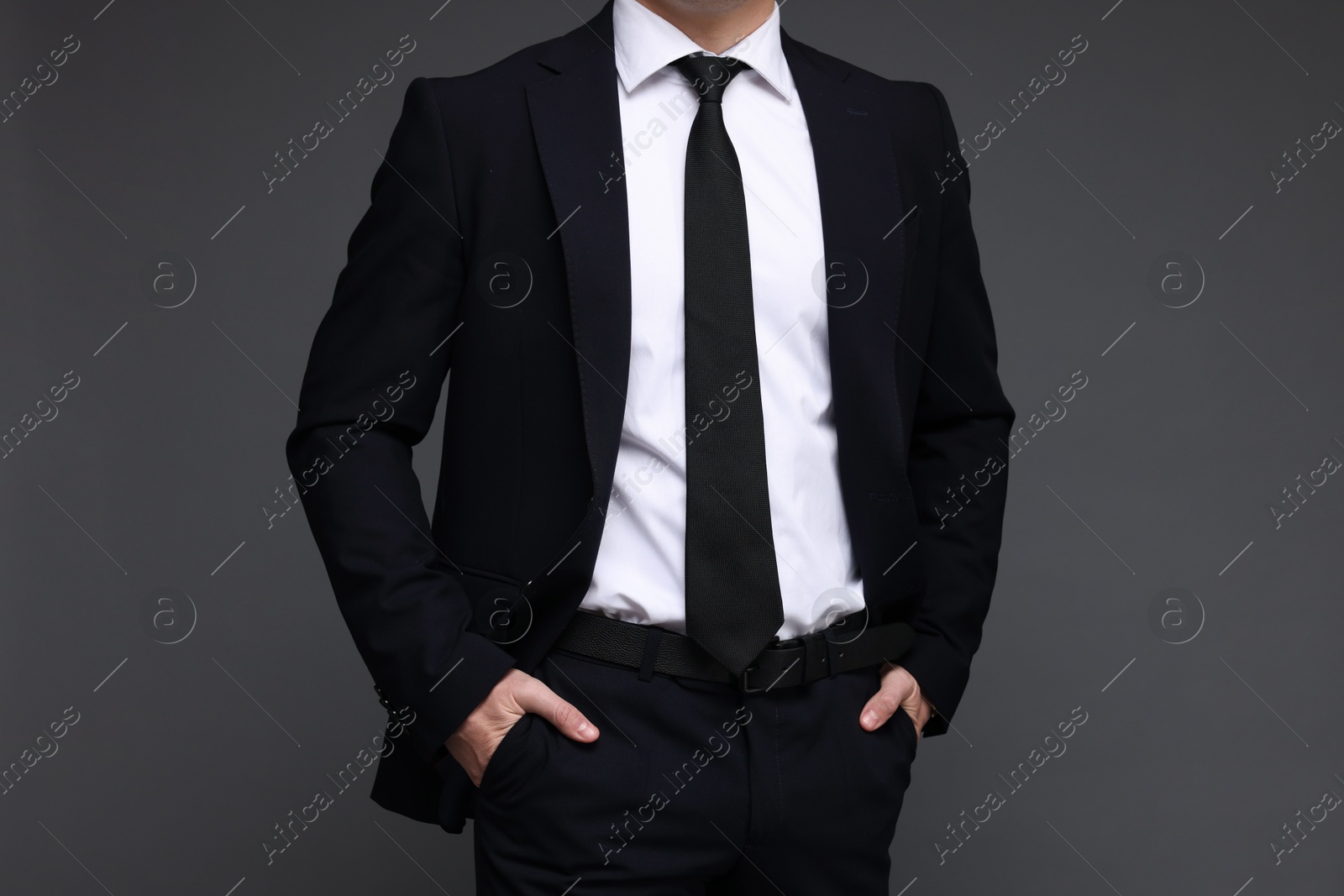 Photo of Man in classic suit on grey background, closeup