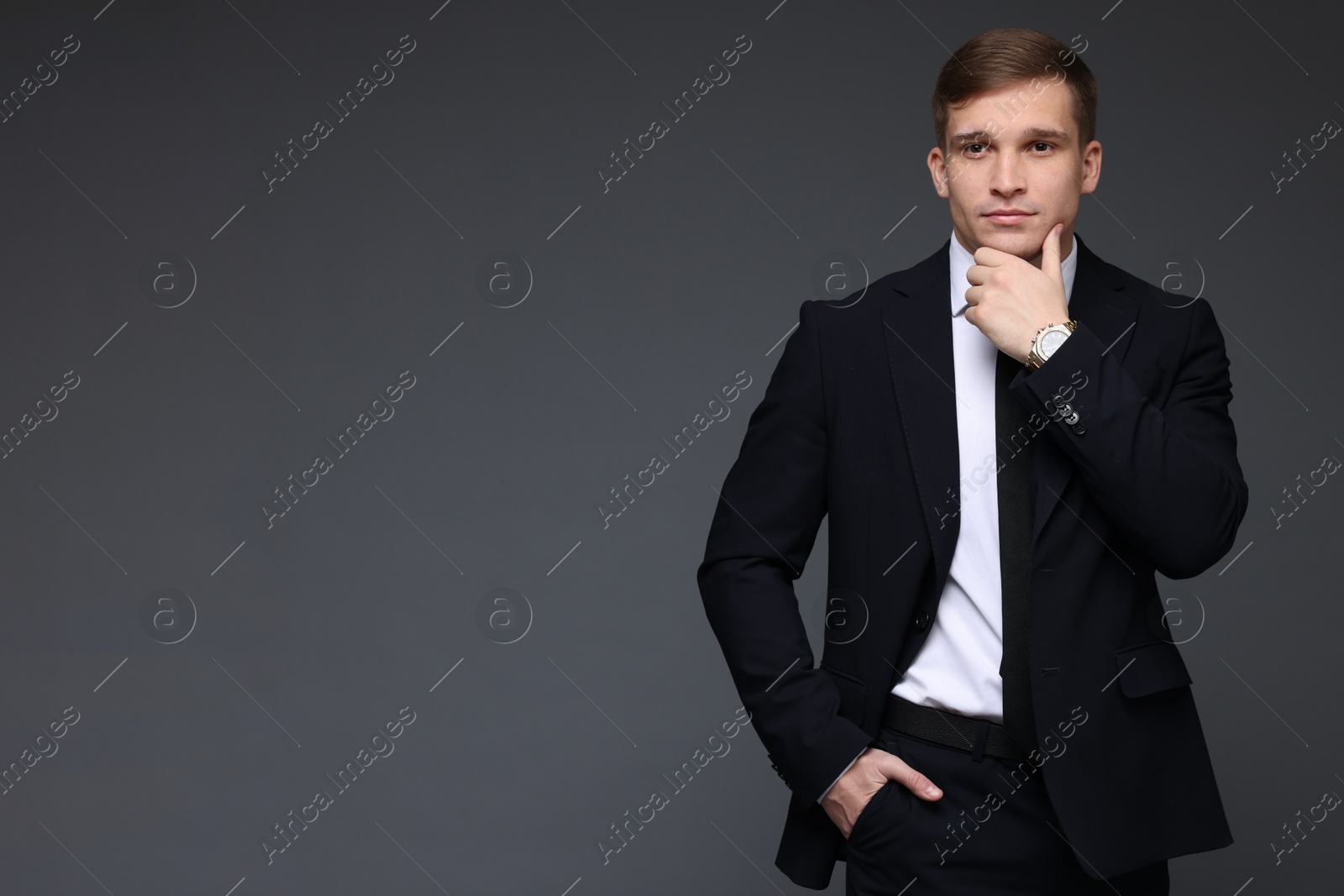 Photo of Man in classic suit with stylish watch on grey background. Space for text