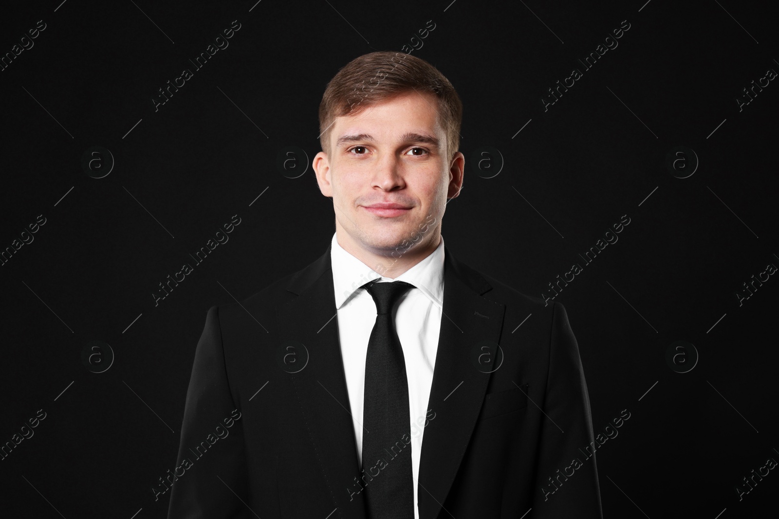 Photo of Man in classic suit on black background