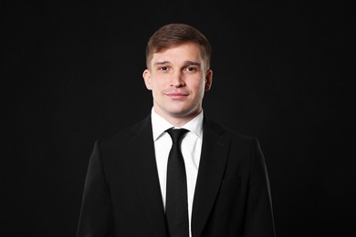 Photo of Man in classic suit on black background