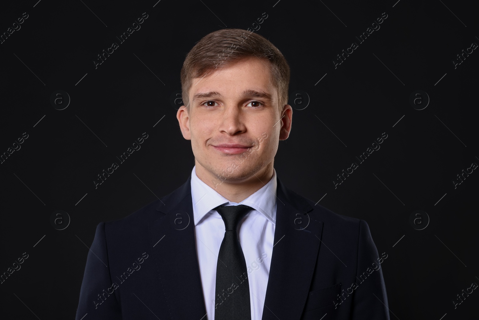 Photo of Man in classic suit on black background