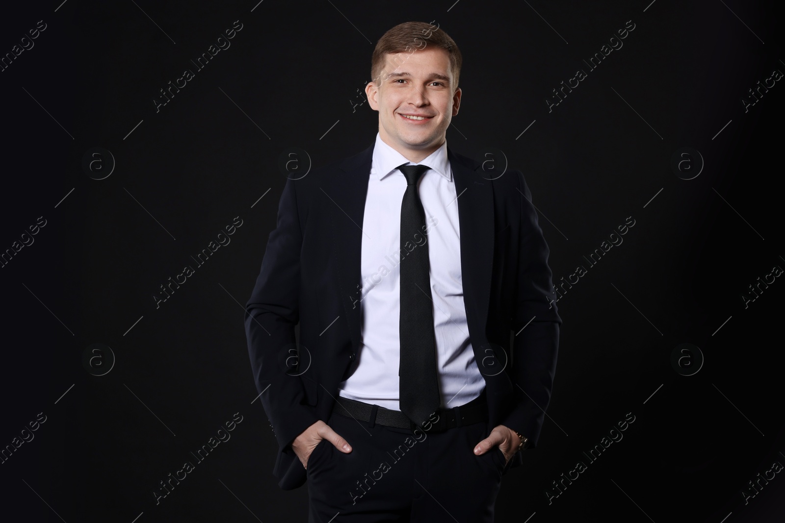 Photo of Man in classic suit on black background