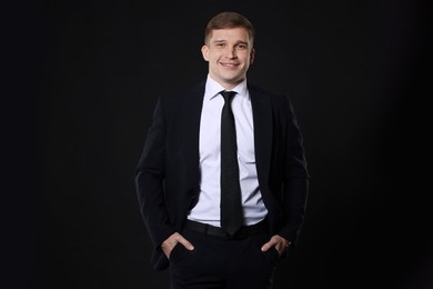 Man in classic suit on black background