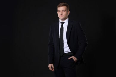 Photo of Man in classic suit on black background