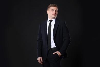 Photo of Man in classic suit on black background