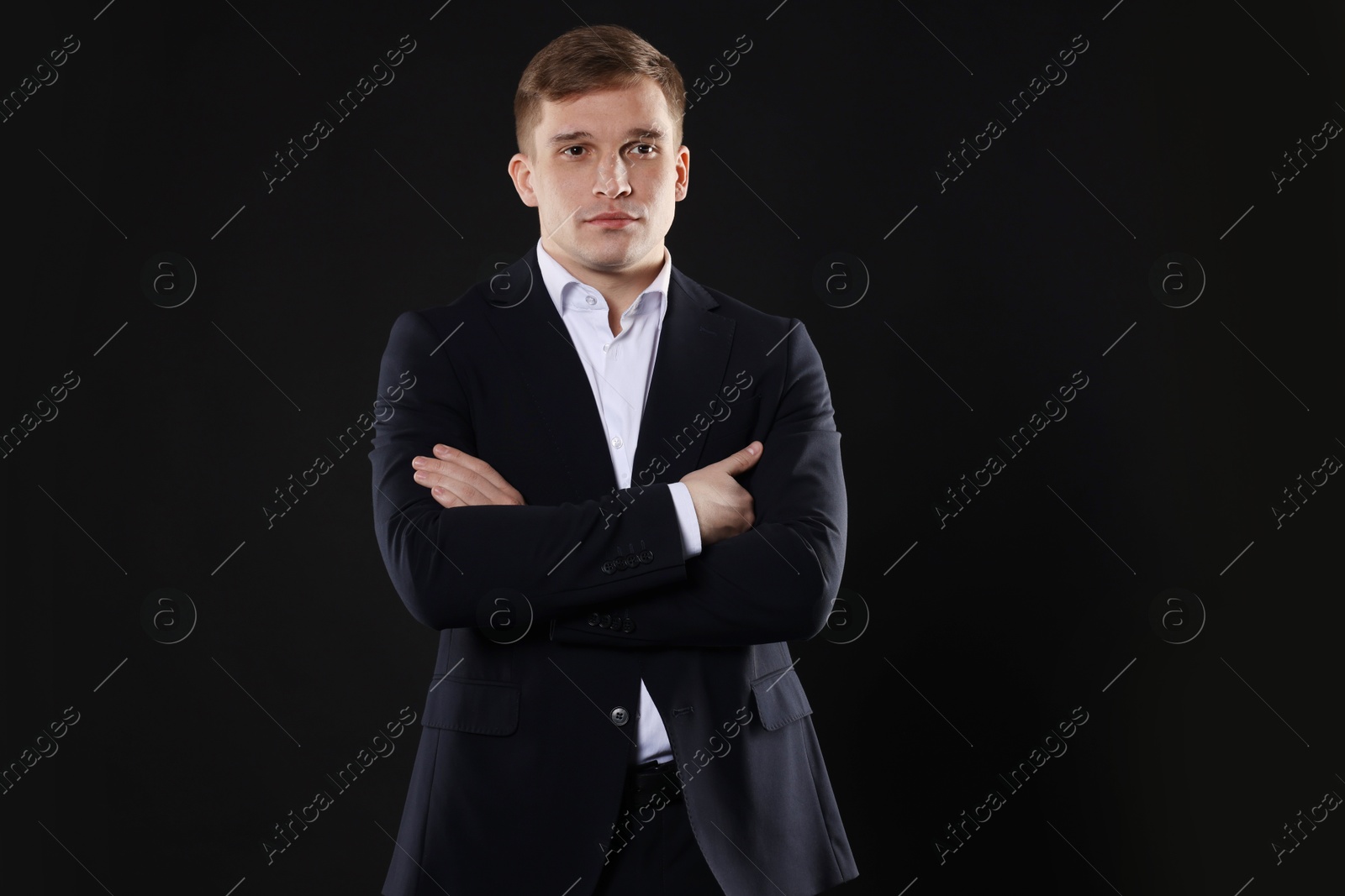 Photo of Man in classic suit on black background