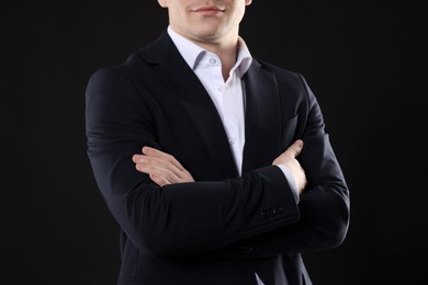 Man in classic suit on black background, closeup