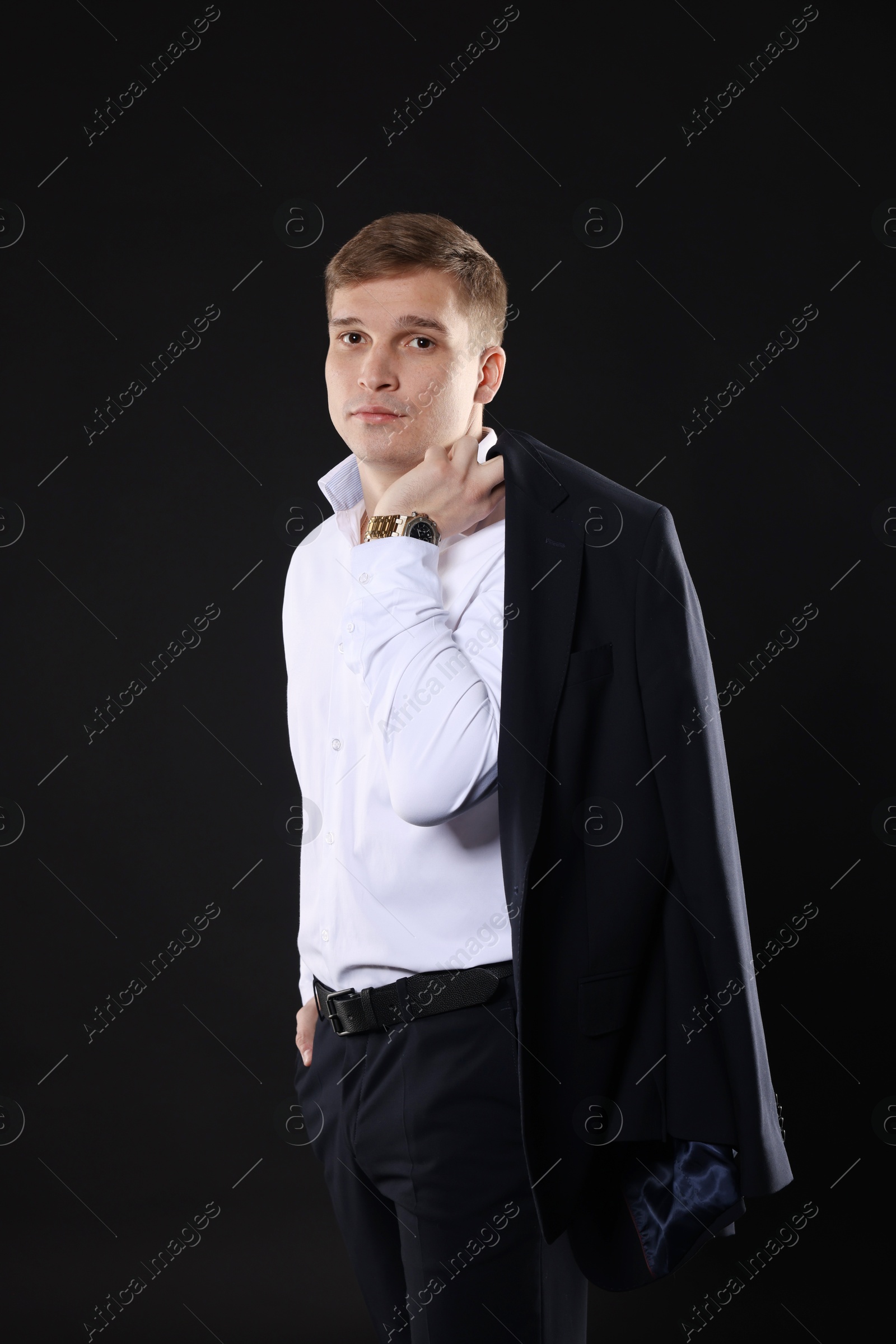 Photo of Man in classic suit on black background