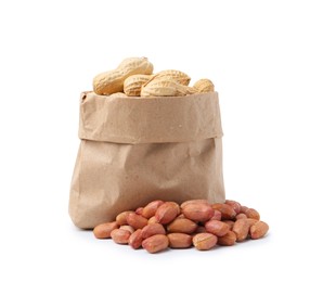 Photo of Fresh peanuts and paper bag isolated on white