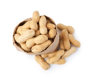 Photo of Unpeeled peanuts and paper bag isolated on white, top view