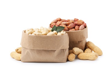 Photo of Different peanuts in paper bags isolated on white