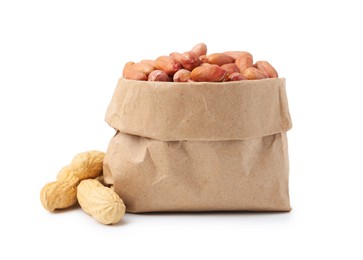 Photo of Fresh peanuts in paper bag and unpeeled ones isolated on white