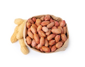 Photo of Fresh peanuts in paper bag and unpeeled ones isolated on white, top view