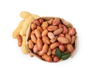 Photo of Fresh peanuts in paper bag and unpeeled ones isolated on white, top view