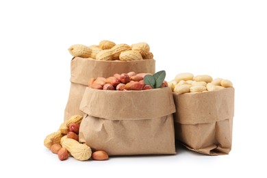 Photo of Different peanuts in paper bags isolated on white