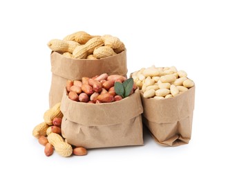 Photo of Different peanuts in paper bags isolated on white